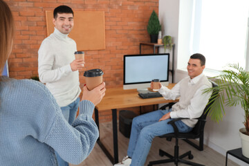 Wall Mural - Business colleagues having coffee break in office, closeup