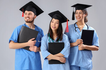 Poster - Medical graduate students with diplomas on white background