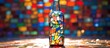 Vibrant and colorful glass bottle featuring a mosaic design with a variety of bright colors and patterns
