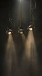 three stage spot lights hanging down on a black background
