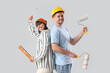 © Pixel-Shot - Young couple with tools on light background. Repair concept