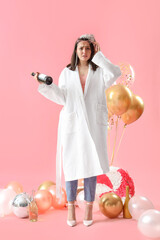 Poster - Young woman in robe with hangover and champagne after Birthday party on pink background