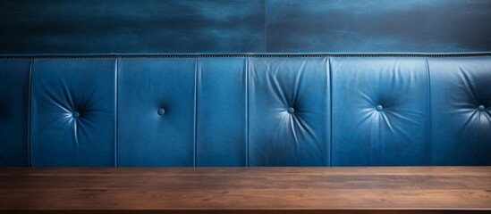 Wall Mural - Close up view of a rustic wooden table set against a vibrant blue painted wall