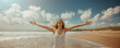Happy woman with arms outstretched enjoying freedom at the beach
