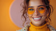 happy woman with yellow sunglasses and sweater on isolated pastel orange background, with purple shapes behind her,generative ai