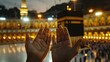 Devout Muslim praying with open hands facing the Kaaba during a serene sunset at the Grand Mosque.