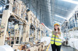 © Nutchapong Wuttisak - Asian Female Engineer Supervisor Owns and manages businesses in European plastics and steel industries. Point your hand at the machine and have a radio. Wear a safety helmet and vest.