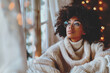 pretty afro american lady in eyeglasses thoughful in a cozy winter room