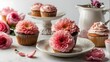 Mother's Day holiday meal including pink flowers and cupcakes on a white background