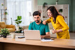 © StockImageFactory - Young Indian couple checking mortgage or loan agreement, financial documents together, using laptop and calculator.