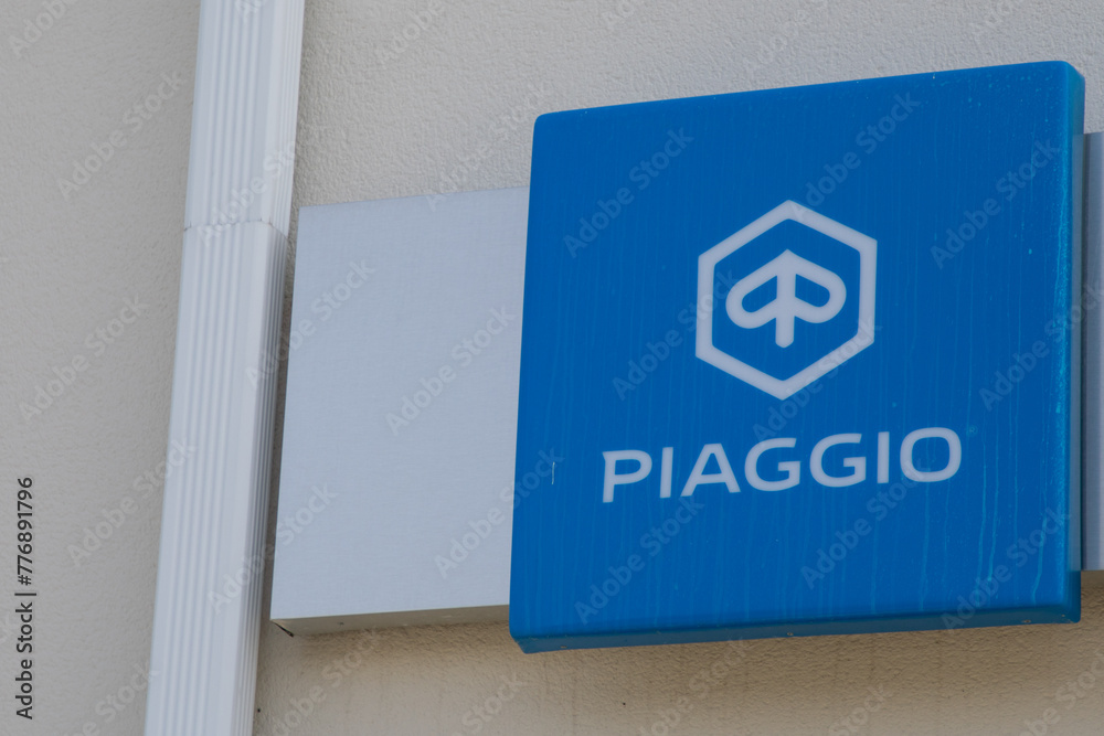 piaggio dealership logo and text sign on shop wall building of italian ...