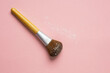 makeup tool powder brush made from wood on pink background, eco cosmetic
