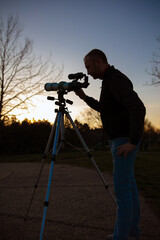 Wall Mural - amateur astronomer observing sun eclipse and sun with a telescope and special solar filter.