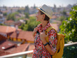 female summer travel to Antalya, Turkey. young asian woman in red dress walk through old town Kalechi , Panoramic view of Antalya Old Town , old otoman houses