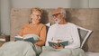 © Stockphotodirectors - Senior couple reading books in bed