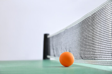 Wall Mural - Ping-pong background with ball on green table and white background