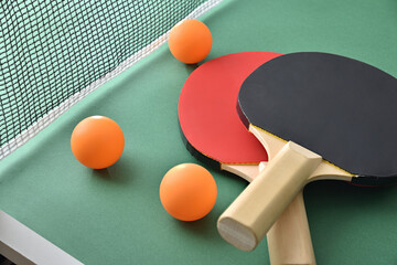 Wall Mural - Ping pong paddles and balls on green game table