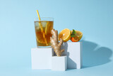 Fototapeta Tulipany - A glass of cold tea on a blue background