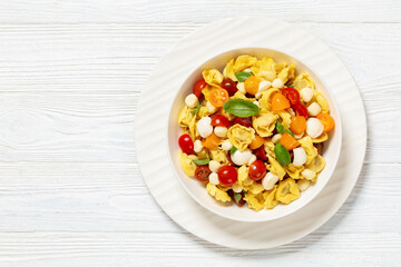 Wall Mural - tortellini salad with tomatoes, mozzarella in bowl