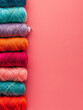 Colourful yarn spools against a bright red background for crafts.