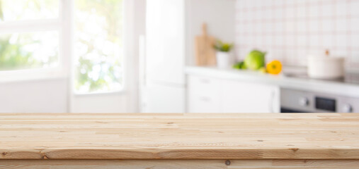 Wall Mural - wooden table top with copy space on blurred kitchen room interior and summer window background