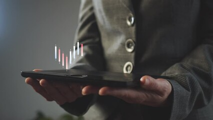 Poster - The growth of indicators reflected by Chinese candles in two colors above the tablet screen in the hands of a businesswoman. Demonstration of effectiveness. Cg