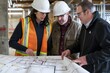 A team of professionals analyzing an architectural floorplan at a construction site, engaging in a discussion about construction details and planning