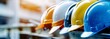 A photo of a row of construction helmets in various colors at a construction site, Safety gear, Construction, Industrial concept