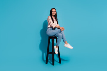 Sticker - Full length photo of positive good mood lady dressed beige shirt sitting chair smiling isolated blue color background