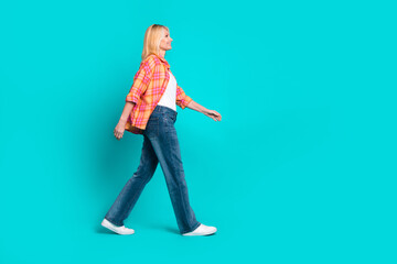 Sticker - Photo of cheerful good mood pretty woman wear stylish clothes going empty space isolated on cyan color background