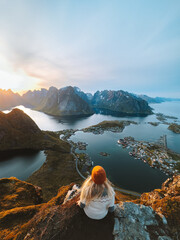 Wall Mural - Woman traveling in Lofoten islands hiking Reinebringen mountain, girl enjoying sunset aerial view in Norway summer active vacations solo traveler outdoor healthy lifestyle adventure trip
