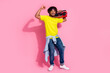 Photo of cheerful glad nice man wear stylish yellow clothes listen music enjoy weekend isolated on pink color background