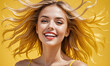 Happy smiling excited young beautiful woman on summer yellow background
