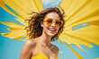 Happy smiling excited young beautiful woman on summer yellow background