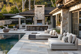 Fototapeta Natura - A chic outdoor living space with plush sofas and loungers by a glistening pool.