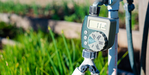 panorama large display of water timer at community garden in dallas, texas, outlet hose faucet digit