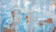 Abstract background of old rusty wall with scraps of blue paint
