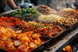 Hot and steamy Asian street food delicacies sizzle in pots and pans at a vibrant street market