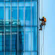 Industrial Climber Washing High-Rise Building Windows