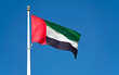 Flag of United Arab Emirates against blue sky