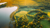 Fototapeta Miasto - Aerial View Of Green Forest And Meadow Hill Landscape Near River. Top View Of Beautiful Nature From High Attitude. Bird's Eye View.