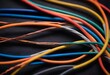 A bundle of colorful insulated copper wires against a dark background
