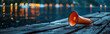 © AI Eye - On a peaceful lakeside, an orange megaphone rests on a weathered dock, the bokeh lights of distant boats dancing on the water's surface