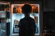 Young child contemplating choices in front of an open refrigerator at night