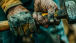 A close-up of the calloused and damaged hands of a construction worker wielding a hammer with precision and experience