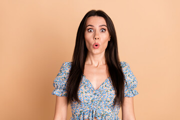 Wall Mural - Photo of shocked impressed cute woman dressed blue trendy flowers print clothes wow news isolated on beige background