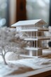 Closeup with a 3D printed house prototype, showcasing technology in real estate