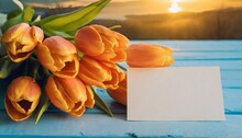 Beautiful Bouquet Of Orange Tulips And Blank Card On Blue Wooden Background