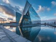 The modern building of the startup, with a triangular shape in the port city located near canals and waterways with a blue sky and clouds, is made from glass and metal blocks