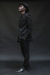 Elegant Man in Stylish Black Attire with Hat Studio Portrait Banner